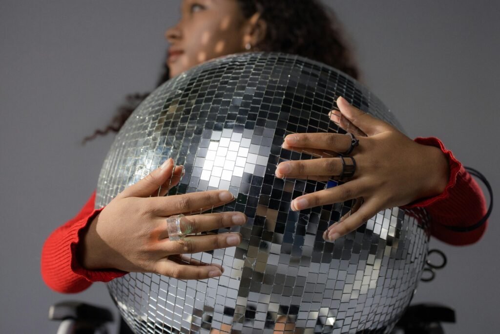 a girl holding a discoball